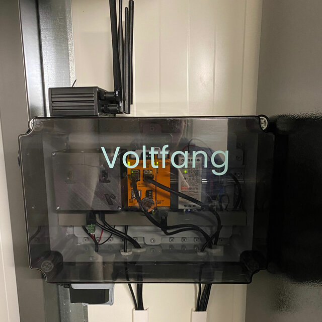 Front view of a transparent Voltfang control unit housing a RevPi Connect, RevPi DIO and other components.